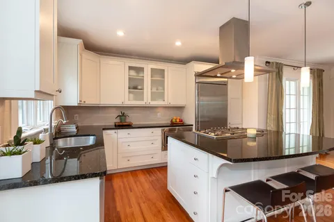 a kitchen with a stove a sink and a refrigerator
