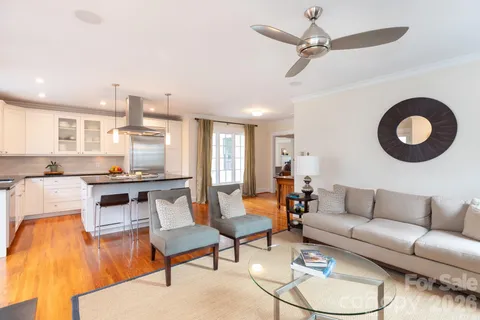 a living room with furniture and kitchen view