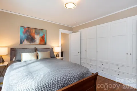 a bedroom with a bed and a painting on the wall