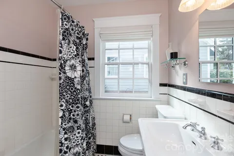 a bathroom with a toilet a sink and a window