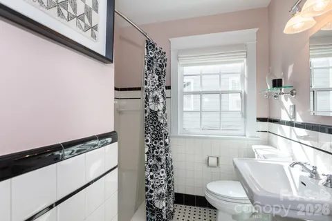 a bathroom with a sink toilet and window