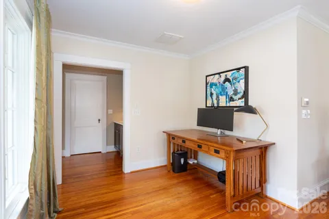 a view of a workspace with furniture and wooden floor