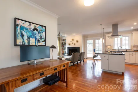 a living room with furniture a fireplace and kitchen view