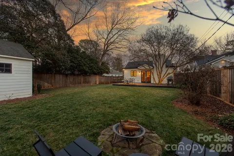 a view of a backyard with plants and a garden