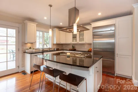 a kitchen with a stove a refrigerator and a sink
