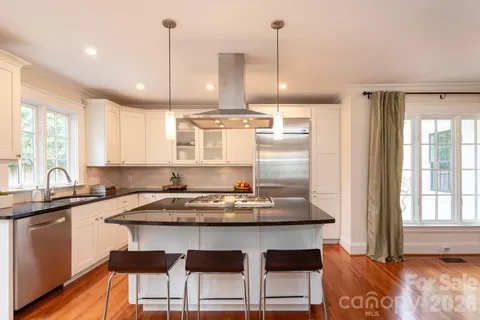 a kitchen with a table chairs stove and cabinets