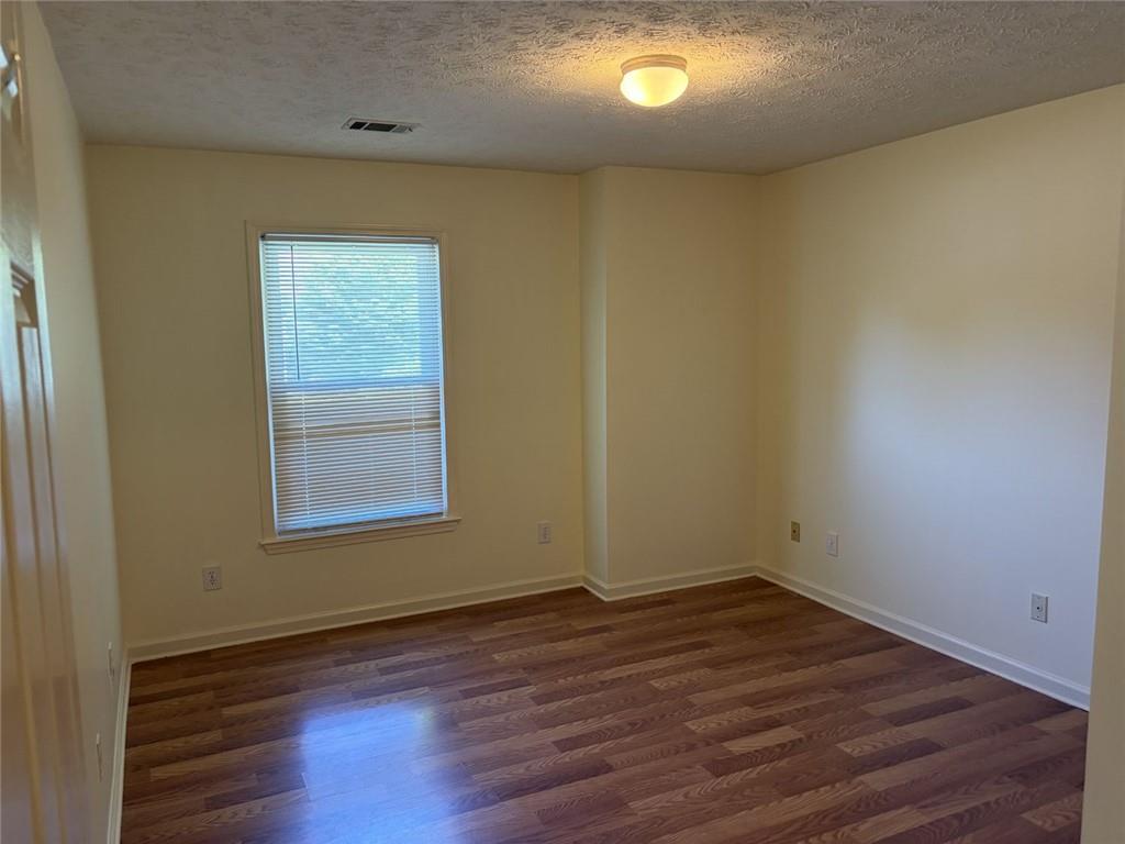 3089 Commons Crossing Snellville, GA 30078 - Photo 10 of 16 an empty room with wooden floor and windows