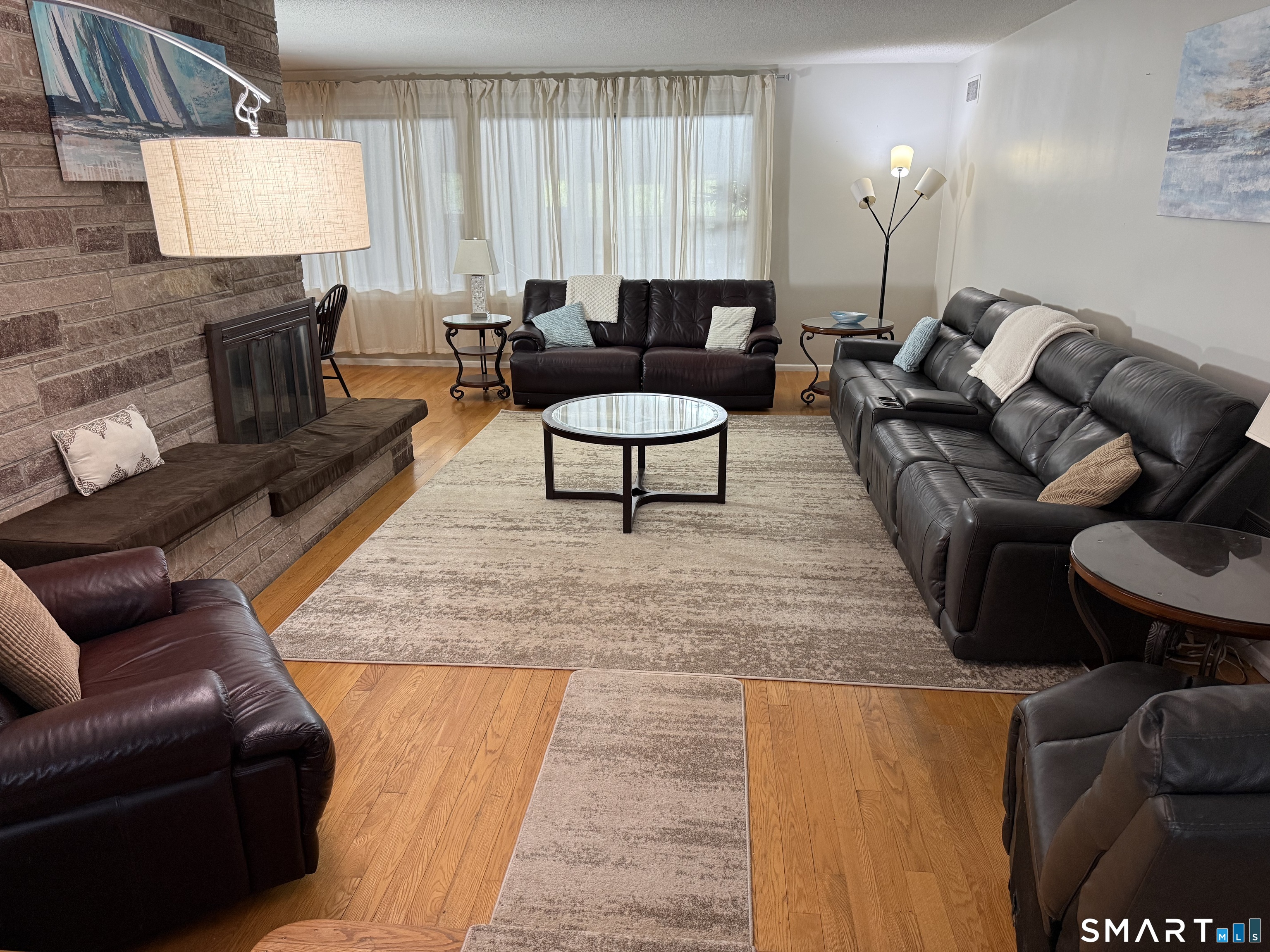 7 Riverview Street Enfield, CT 06082 - Photo 3 of 29 a living room with furniture and a lamp