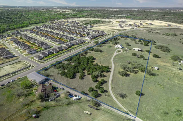 an aerial view of a residential houses with outdoor space
