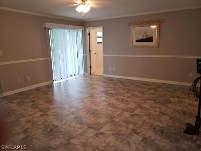 18 Kentucky Road Lehigh Acres, FL 33936 - Photo 6 of 34 an empty room with a mirror and a window