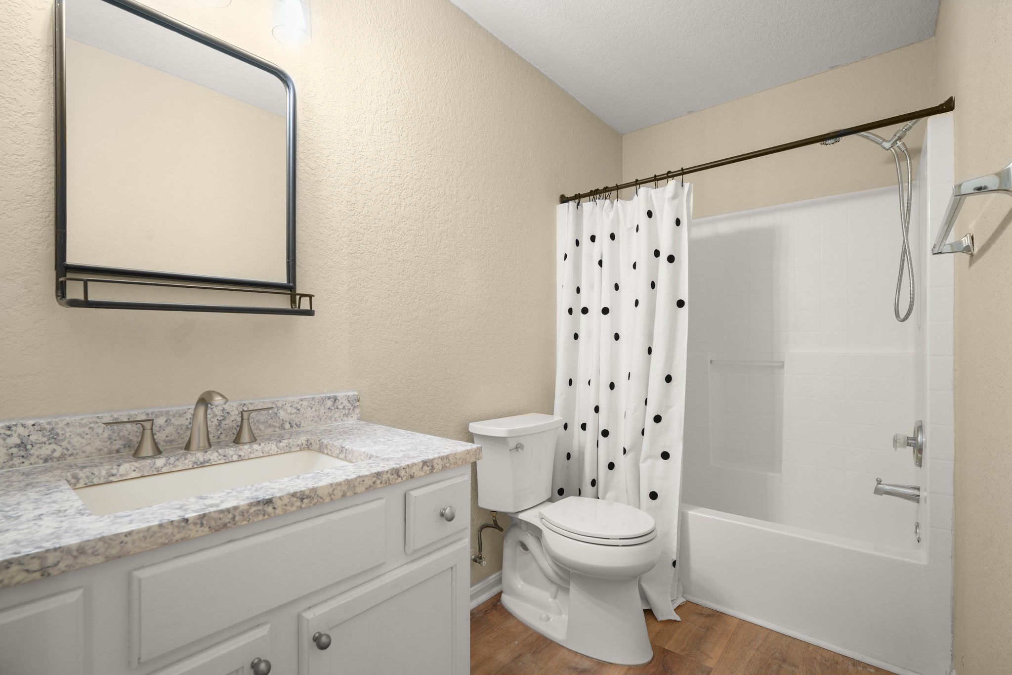 438 Katy Crossing Georgetown, TX 78626 - Photo 18 of 24 A well-appointed bath features a sleek vanity, convenient commode, and an inviting shower-tub combination.