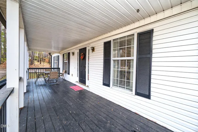 a view of porch with wooden floor and floor to ceiling window