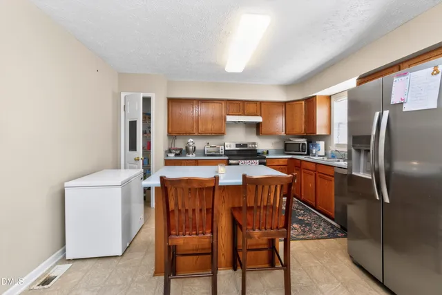 a kitchen with stainless steel appliances a refrigerator stove microwave and sink