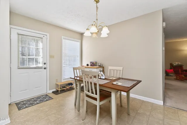 a view of a dining room with furniture and window