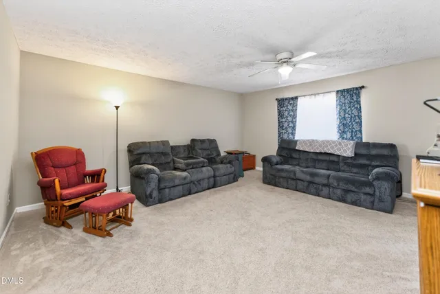 a bedroom with a bed and a flat tv screen on dresser