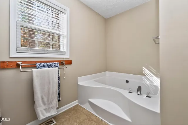 a view of walk in closet with clothes