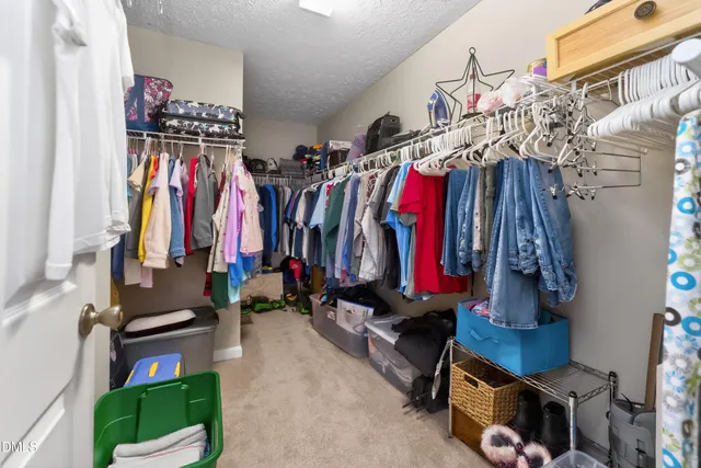 a kitchen with a sink and a stove with white countertops