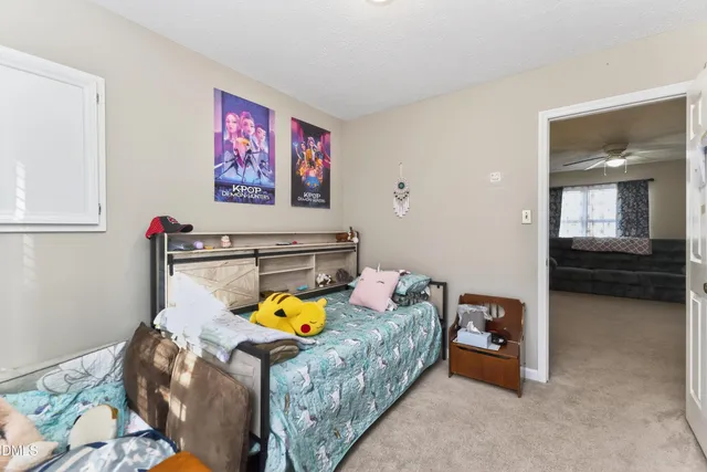 a bedroom with a bed and dresser