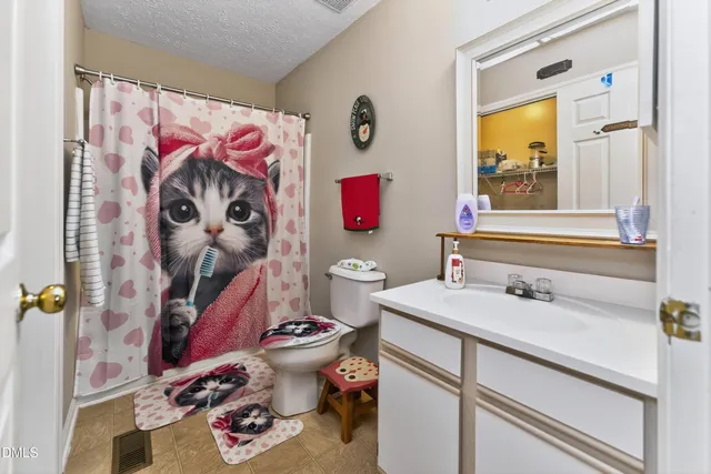 a living room with furniture and a dining table