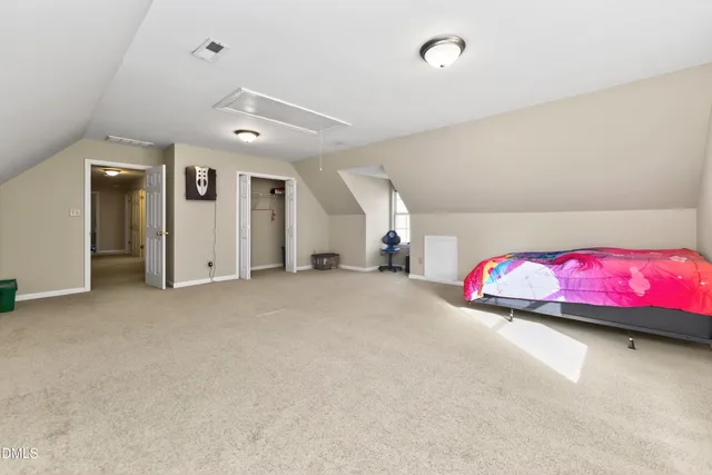 a living room with furniture a flat screen tv and a table