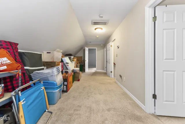 a view of swimming pool with large trees and wooden fence