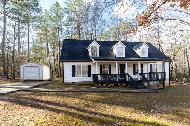 a house that has a tree in front of it
