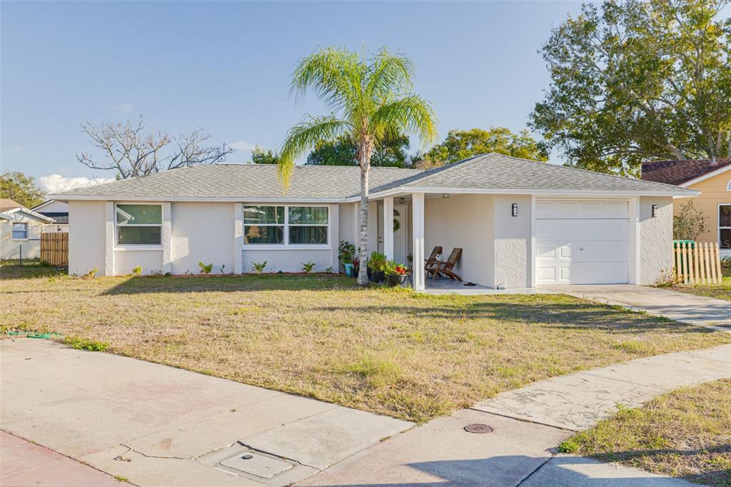 4232 Canandaigua Court New Port Richey, FL 34653 - Photo 1 of 1 a front view of a house with a garden