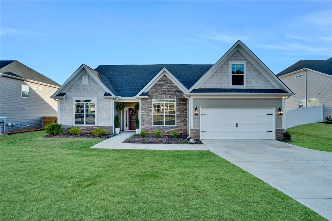 142 Juniper Hill Drive Easley, SC 29642 - Photo 2 of 47 This charming home offers a welcoming facade with a mix of siding and stone accents.