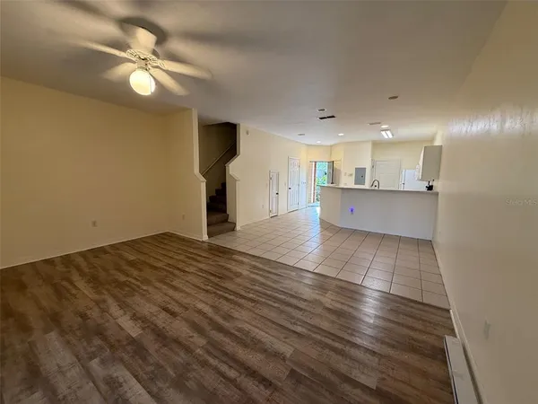 a view of kitchen and hall with wooden floor