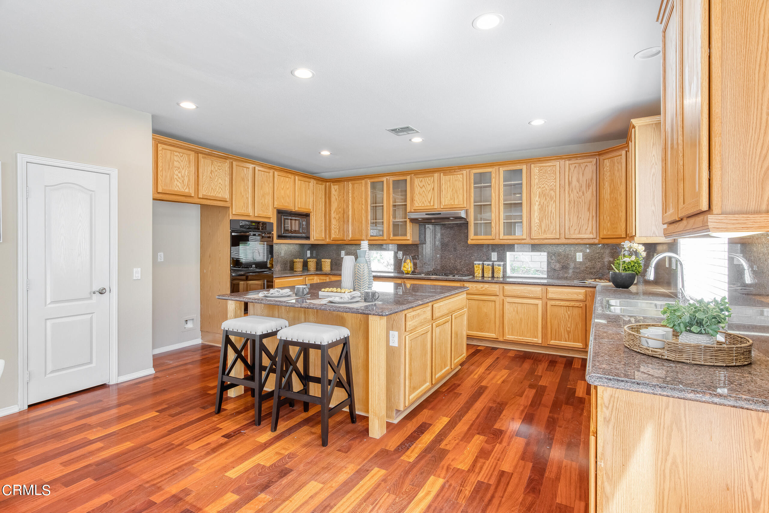26569 Shakespeare Lane Stevenson Ranch, CA 91381 - Photo 15 of 55 a large kitchen with lots of counter top space and stainless steel appliances
