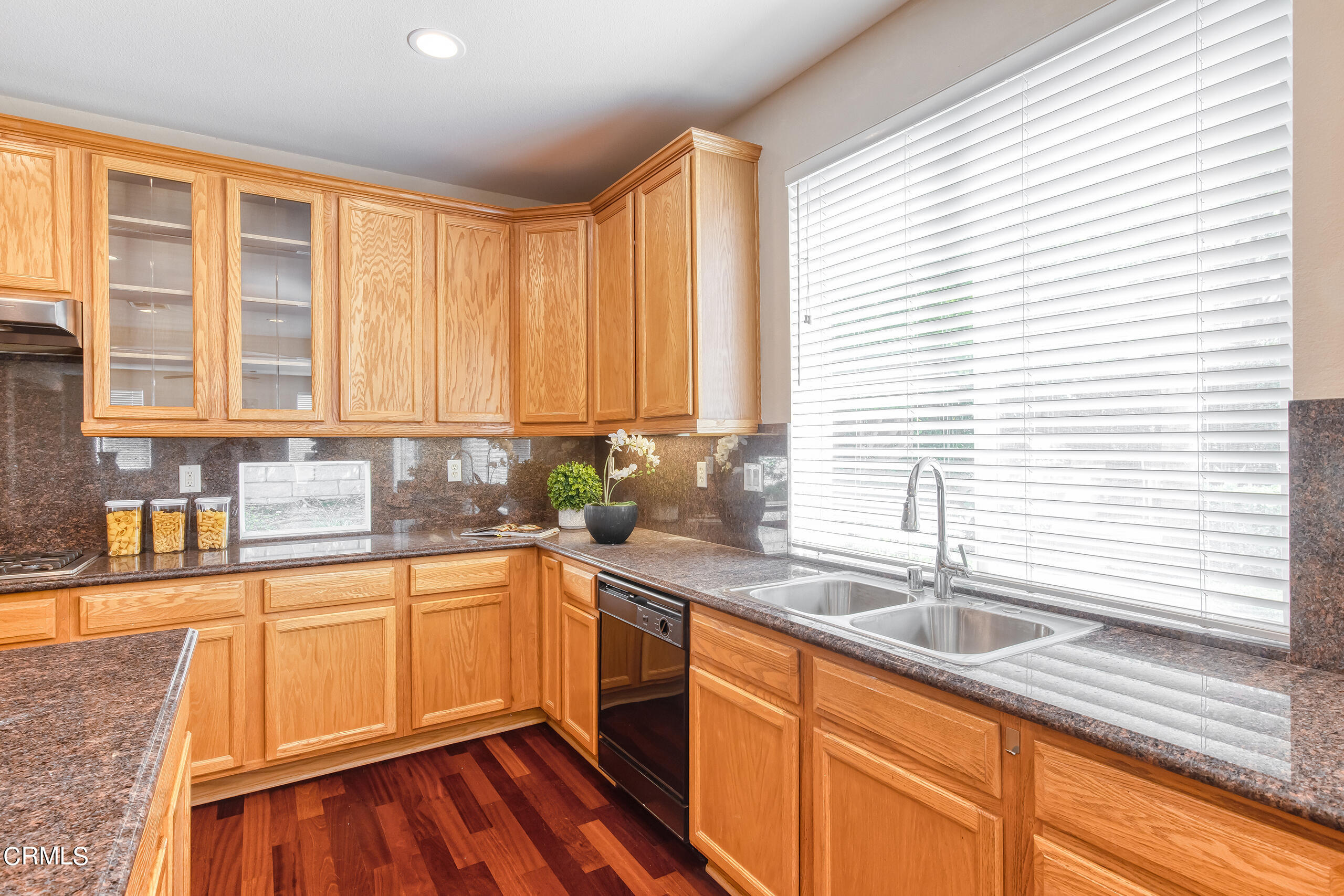 26569 Shakespeare Lane Stevenson Ranch, CA 91381 - Photo 17 of 55 a kitchen with stainless steel appliances a sink a counter space and a window