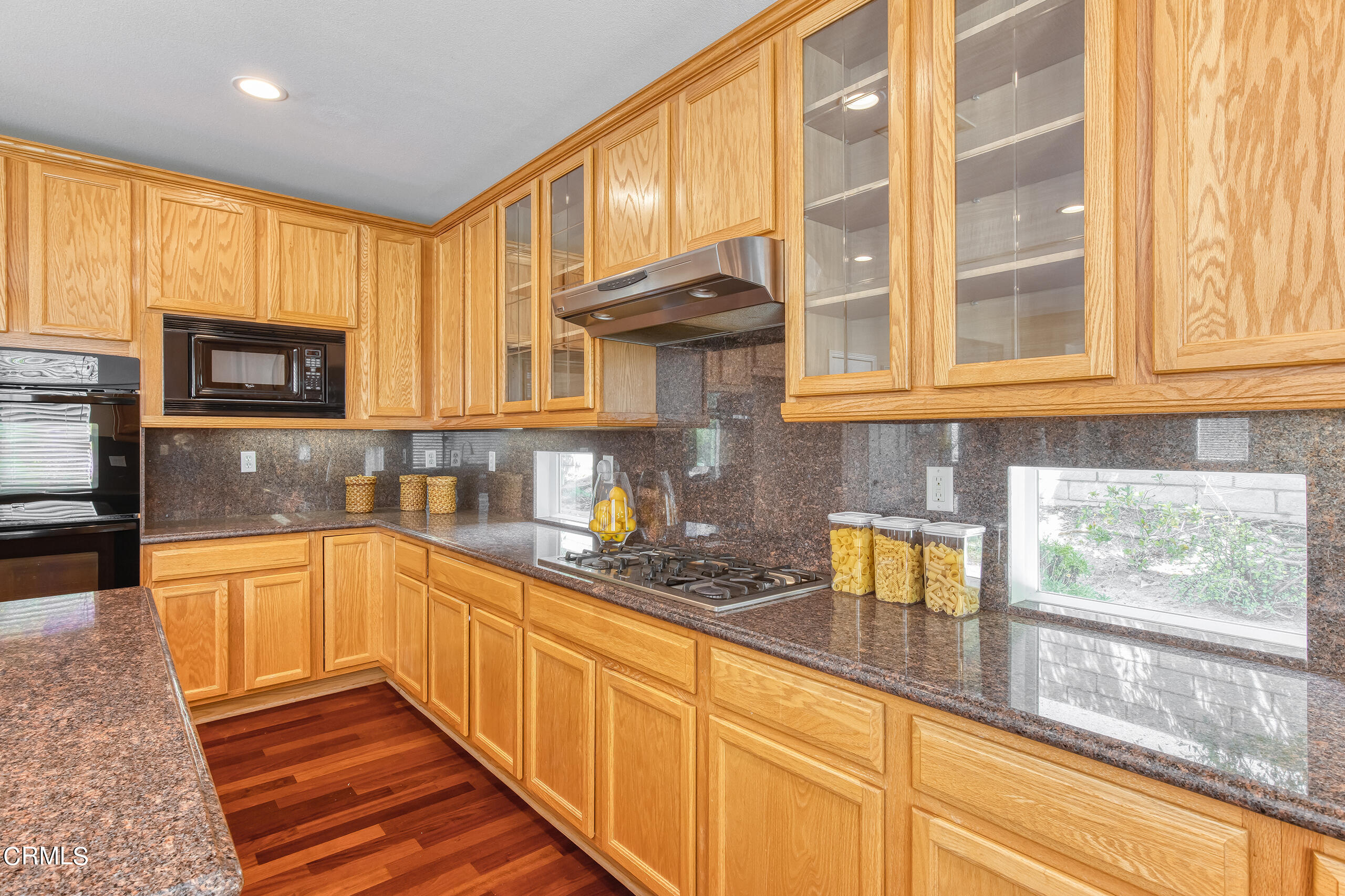 26569 Shakespeare Lane Stevenson Ranch, CA 91381 - Photo 18 of 55 a kitchen with stainless steel appliances granite countertop a stove a sink and a microwave
