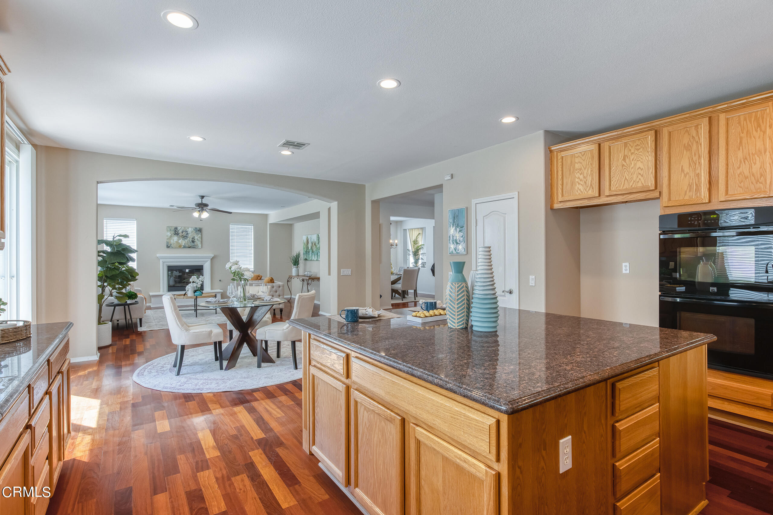 26569 Shakespeare Lane Stevenson Ranch, CA 91381 - Photo 19 of 55 a dining hall with stainless steel appliances granite countertop a stove and a view of living room