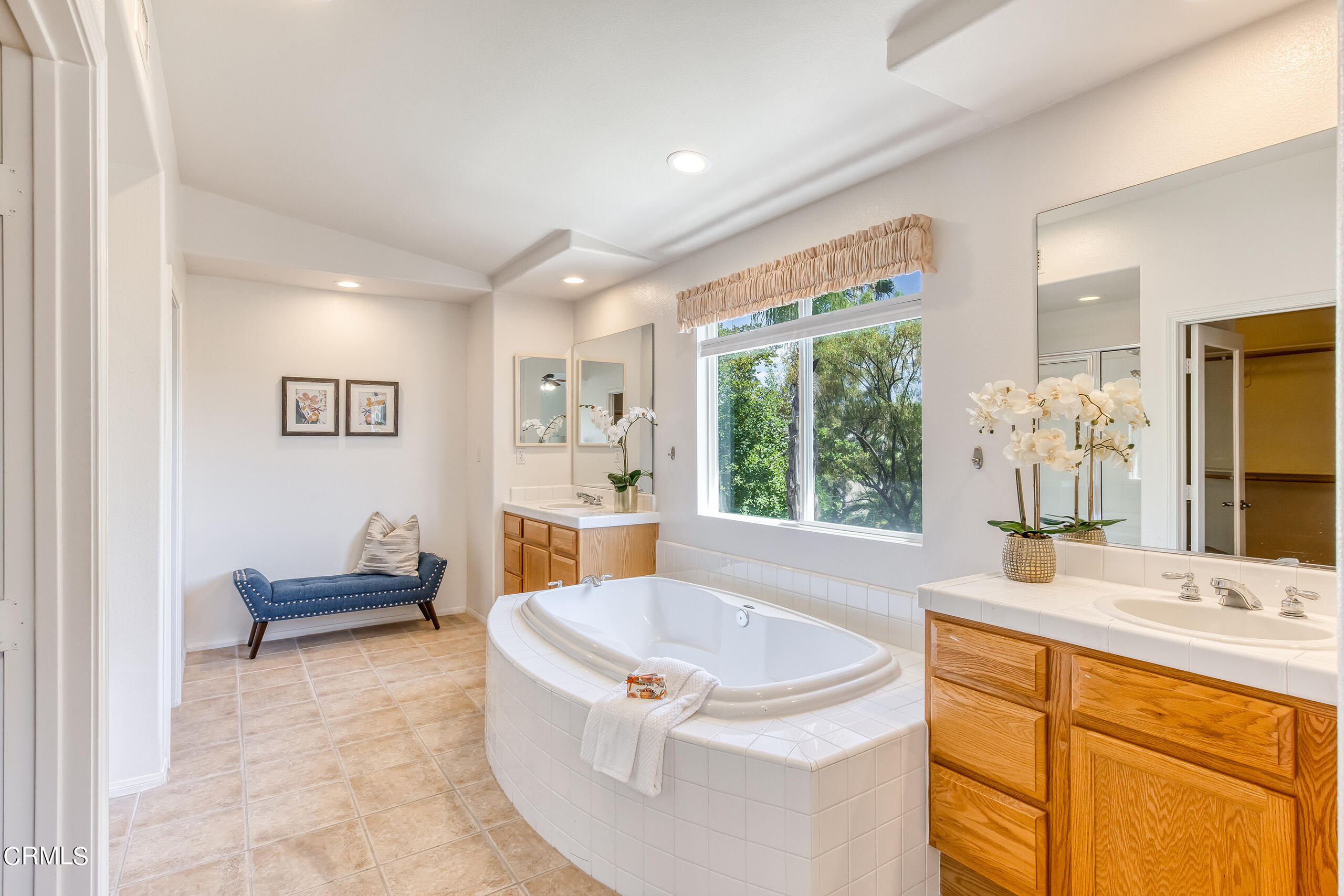 26569 Shakespeare Lane Stevenson Ranch, CA 91381 - Photo 28 of 55 a bathroom with a tub sink and mirror