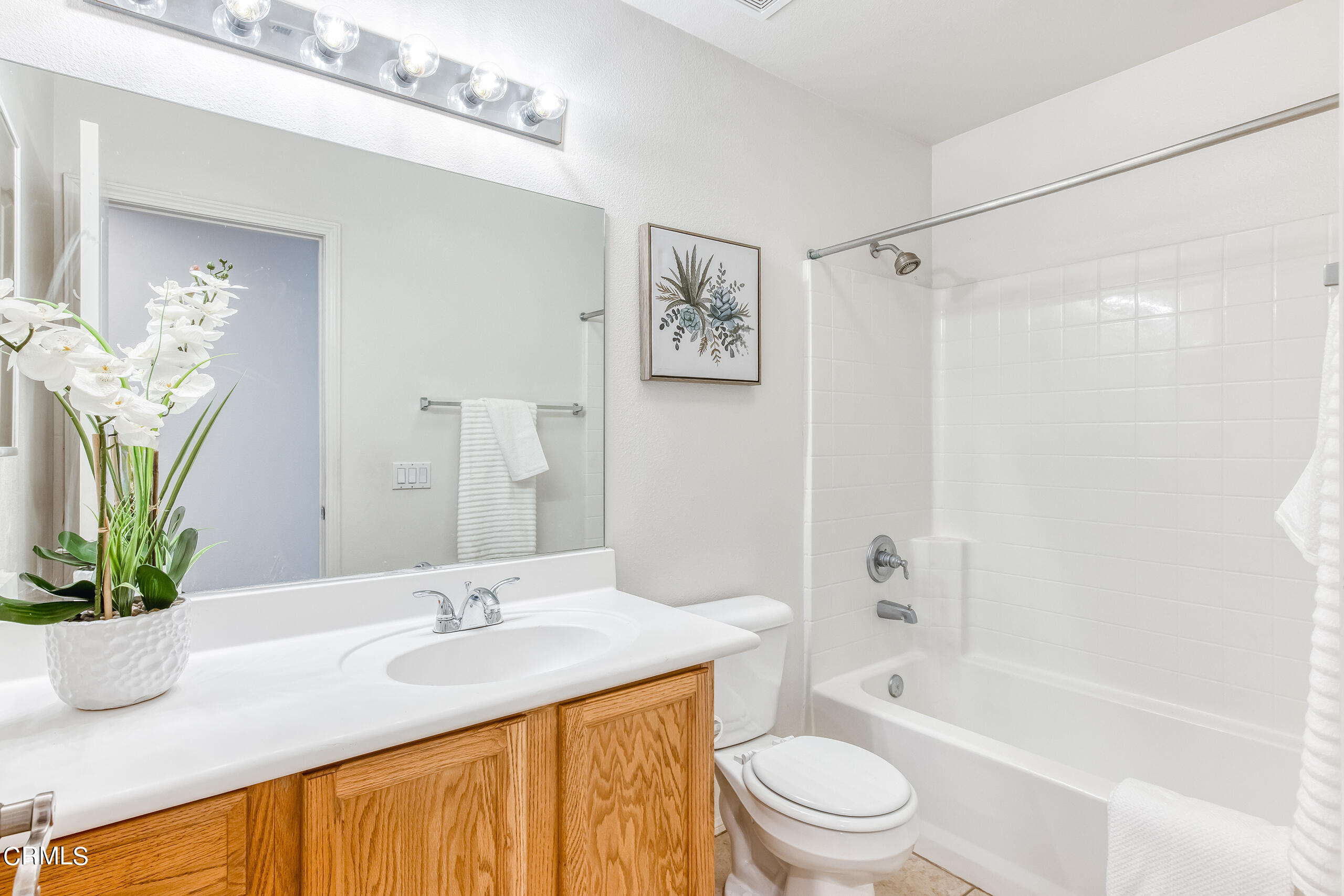 26569 Shakespeare Lane Stevenson Ranch, CA 91381 - Photo 38 of 55 a bathroom with a granite countertop sink a toilet a mirror a vanity a shower and bathtub