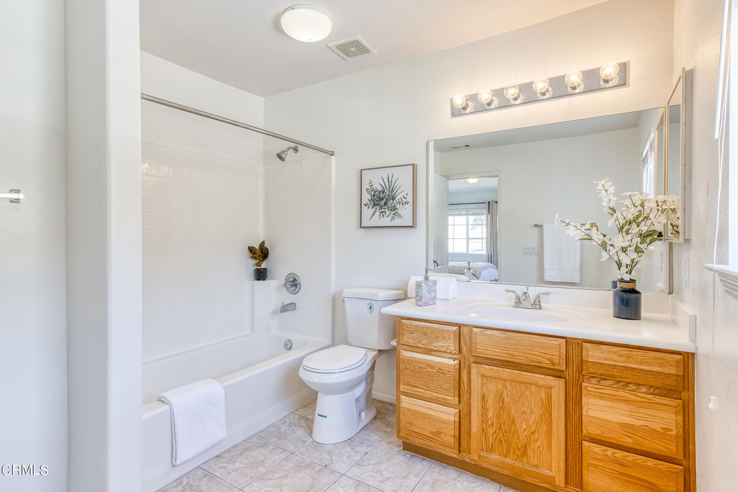 26569 Shakespeare Lane Stevenson Ranch, CA 91381 - Photo 40 of 55 a bathroom with a granite countertop sink a toilet a large mirror a bathtub and shower