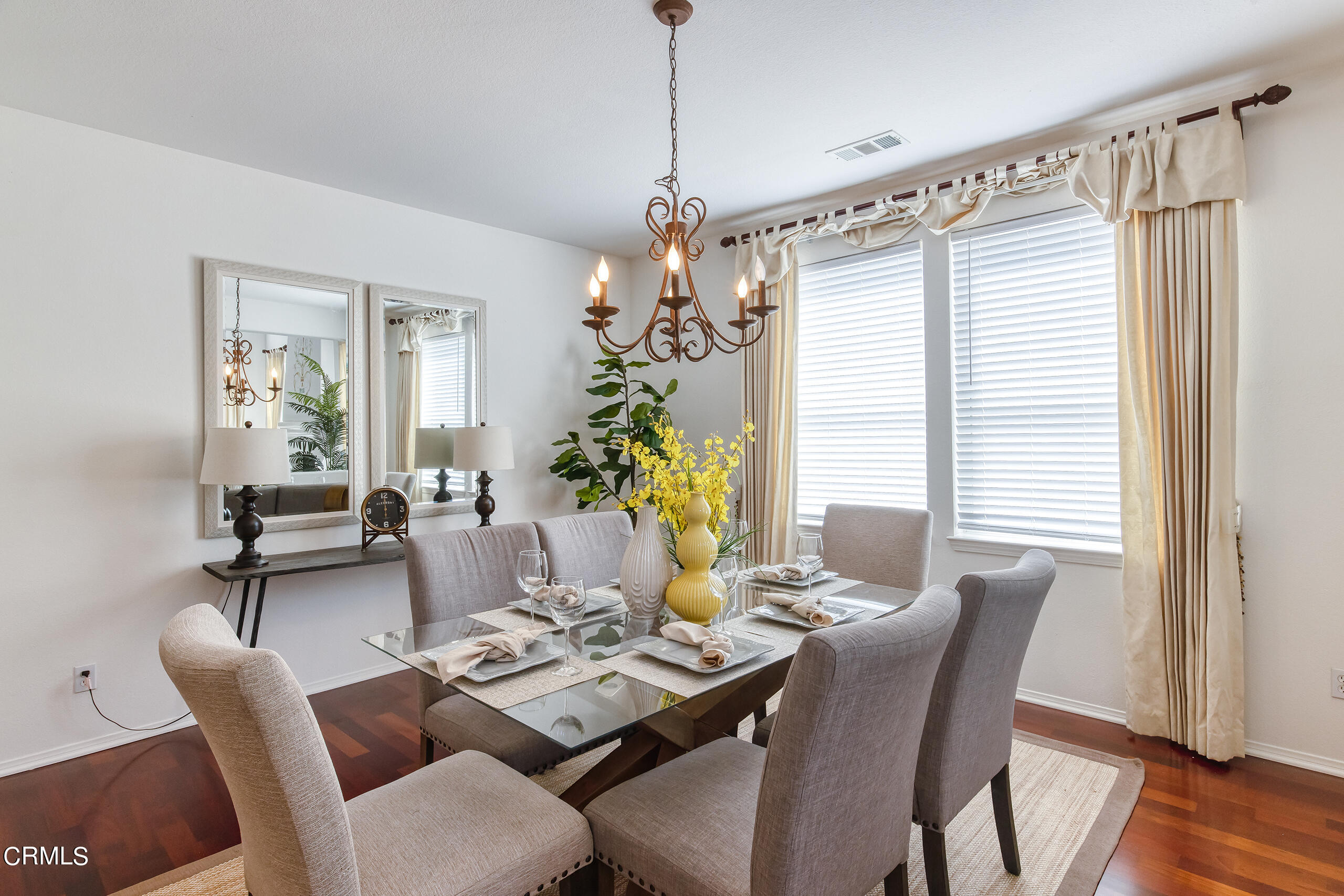 26569 Shakespeare Lane Stevenson Ranch, CA 91381 - Photo 8 of 55 a dining room with furniture a chandelier and wooden floor