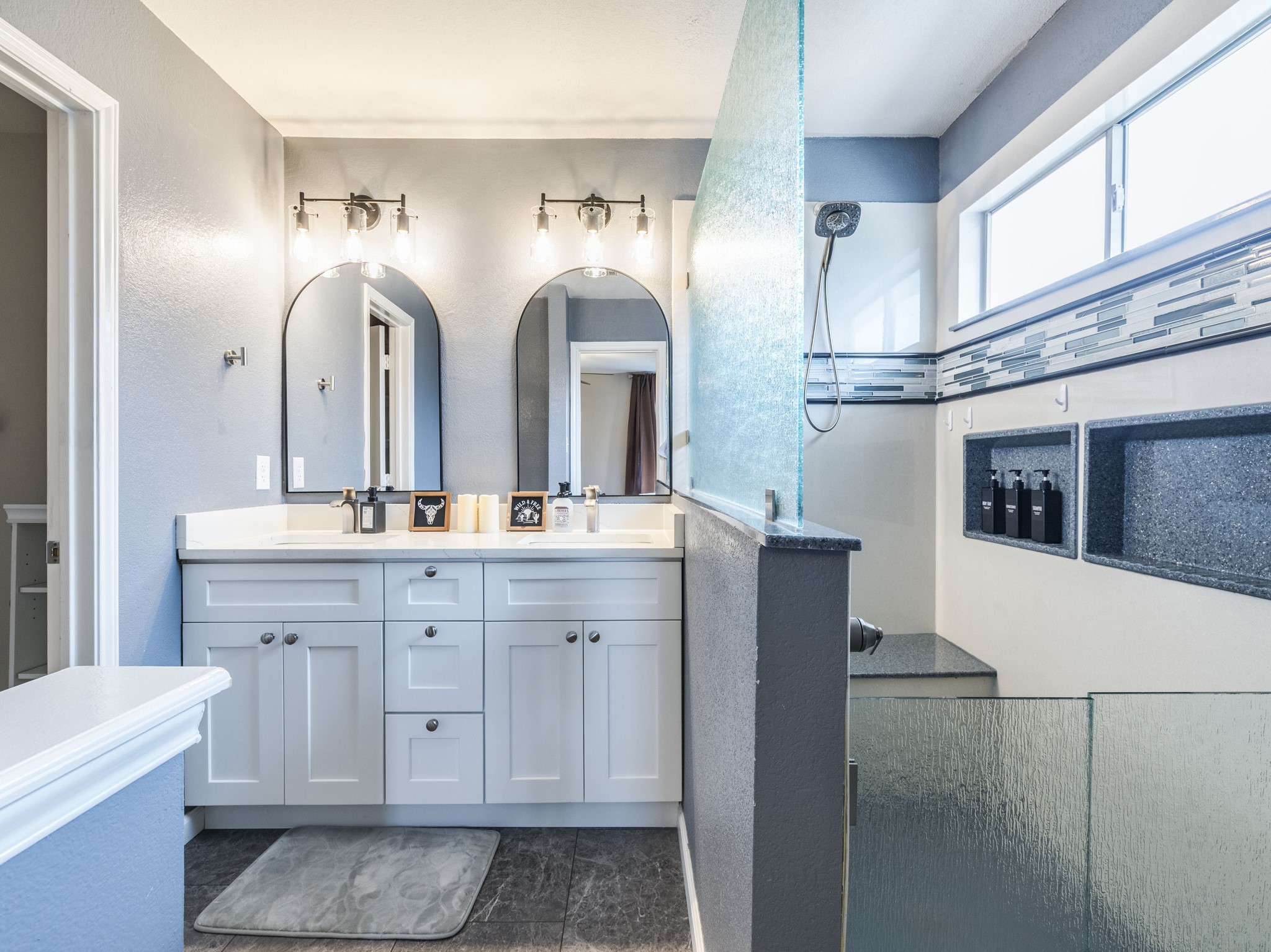 1415 Roxanne's Run Pflugerville, TX 78660 - Photo 2 of 30 Dual vanities and a spacious walk-in shower elevate this bathroom's design.