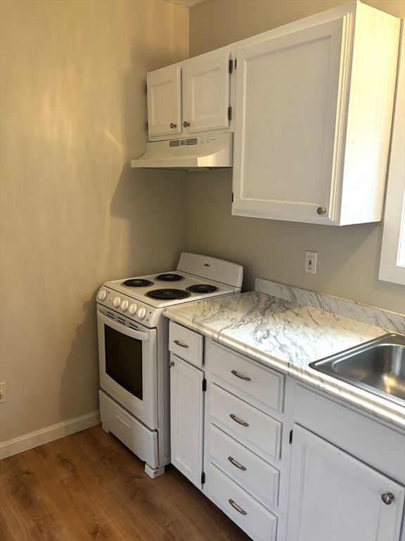 13 Dock Lane Salisbury, MA 01952 - Photo 17 of 23 a kitchen with granite countertop a sink and a stove