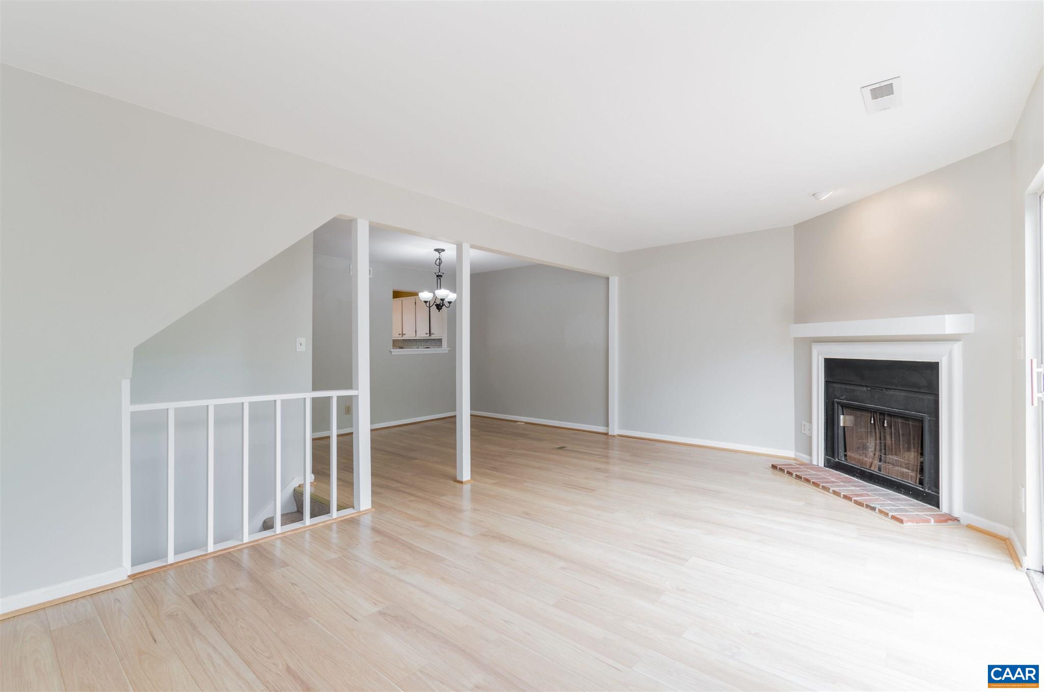 1548 Cool Spring Road Charlottesville, VA 22901 - Photo 17 of 37 a view of an empty room with wooden floor fireplace and a window