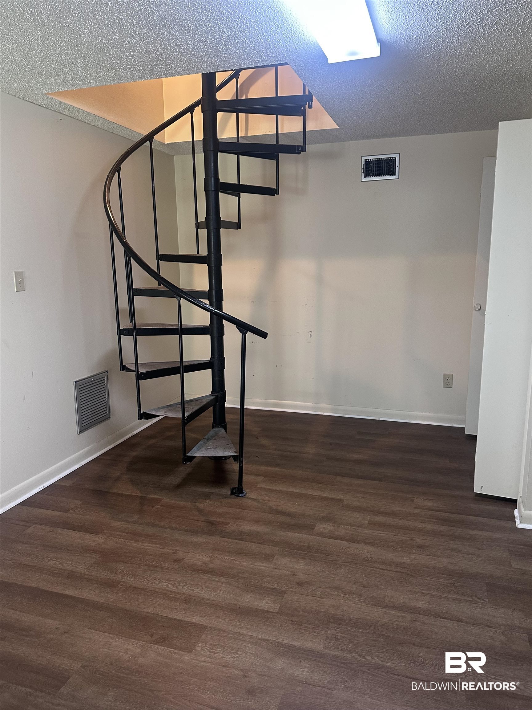2785 Sowell Road Brewton, AL 36426 - Photo 23 of 24 Below grade area featuring a textured ceiling and dark wood-type flooring