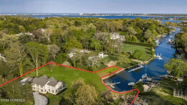 an aerial view of a house with a lake view