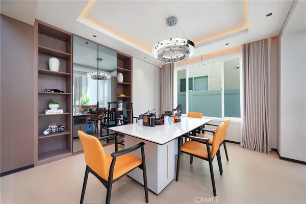 a view of a dining room with furniture and a chandelier