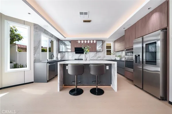 a kitchen with white cabinets and stainless steel appliances