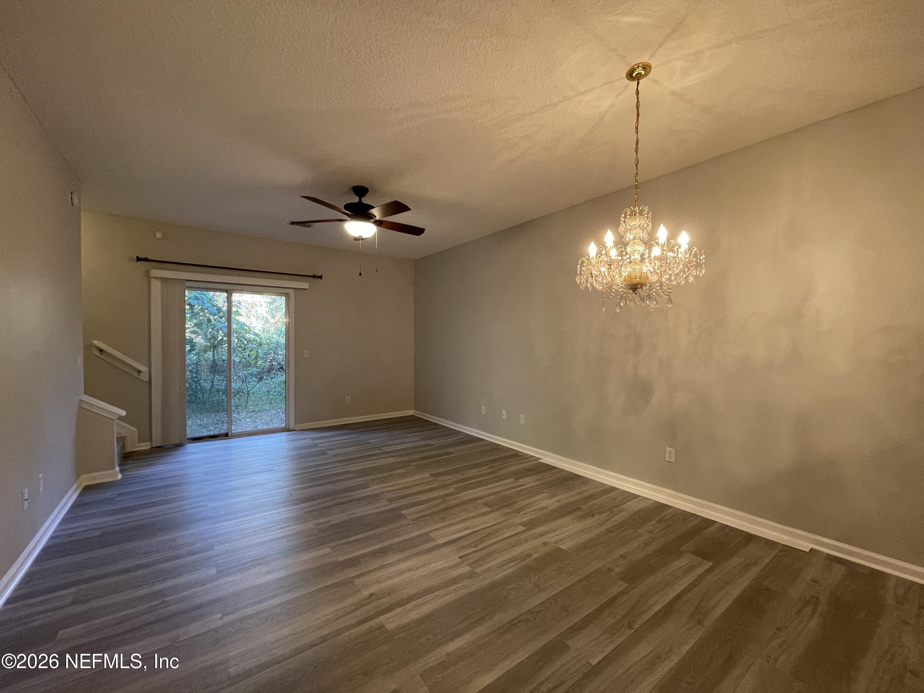 7931 Melvin Road Jacksonville, FL 32210 - Photo 3 of 18 a view of an empty room with a window and wooden floor