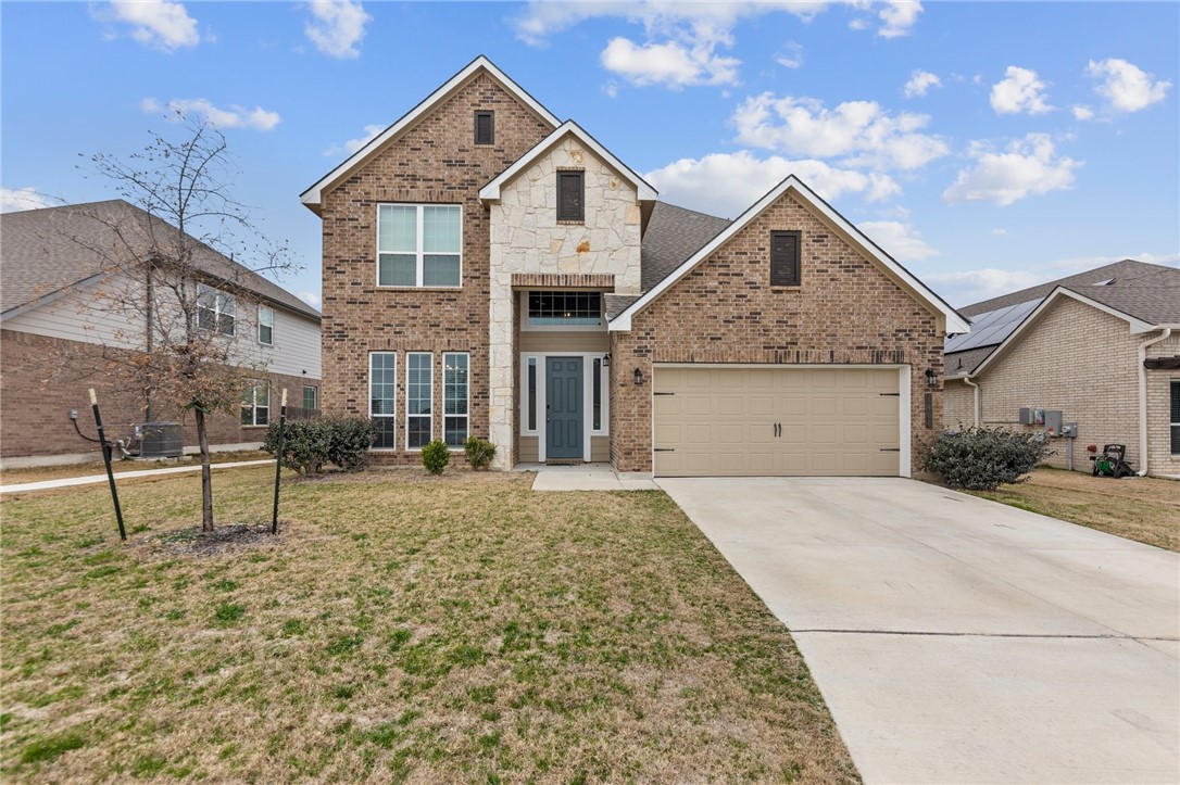 1906 Longmire Loop Temple, TX 76502 - Photo 1 of 32 a front view of a house with a yard and garage