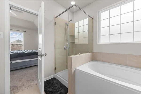 a bathroom with a tub shower and sink