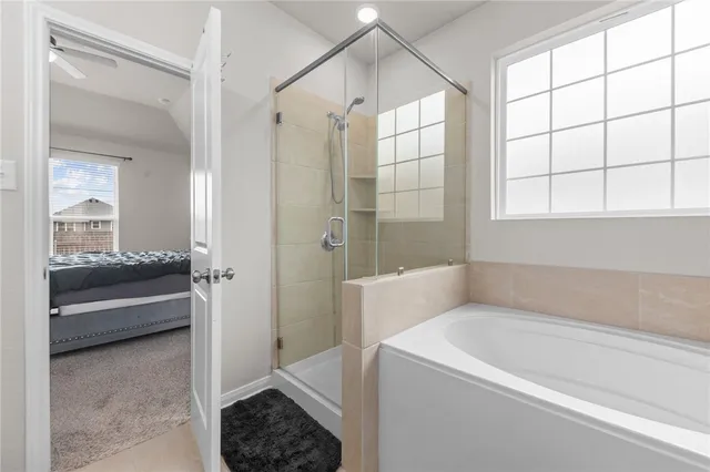 a bathroom with a tub shower and sink