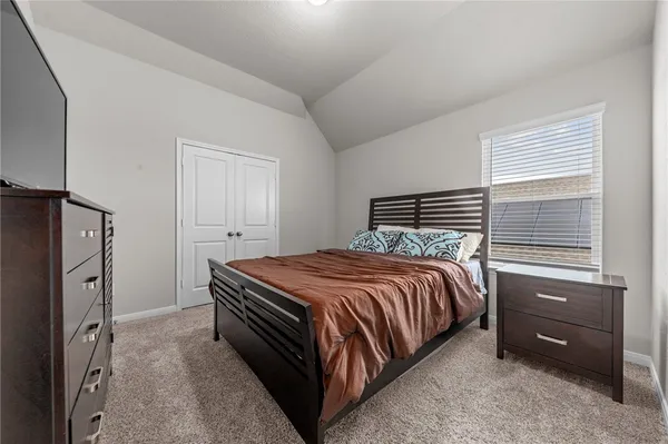 a bedroom with a bed and a closet