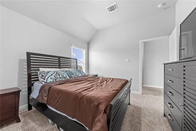 a bedroom with a bed and dresser